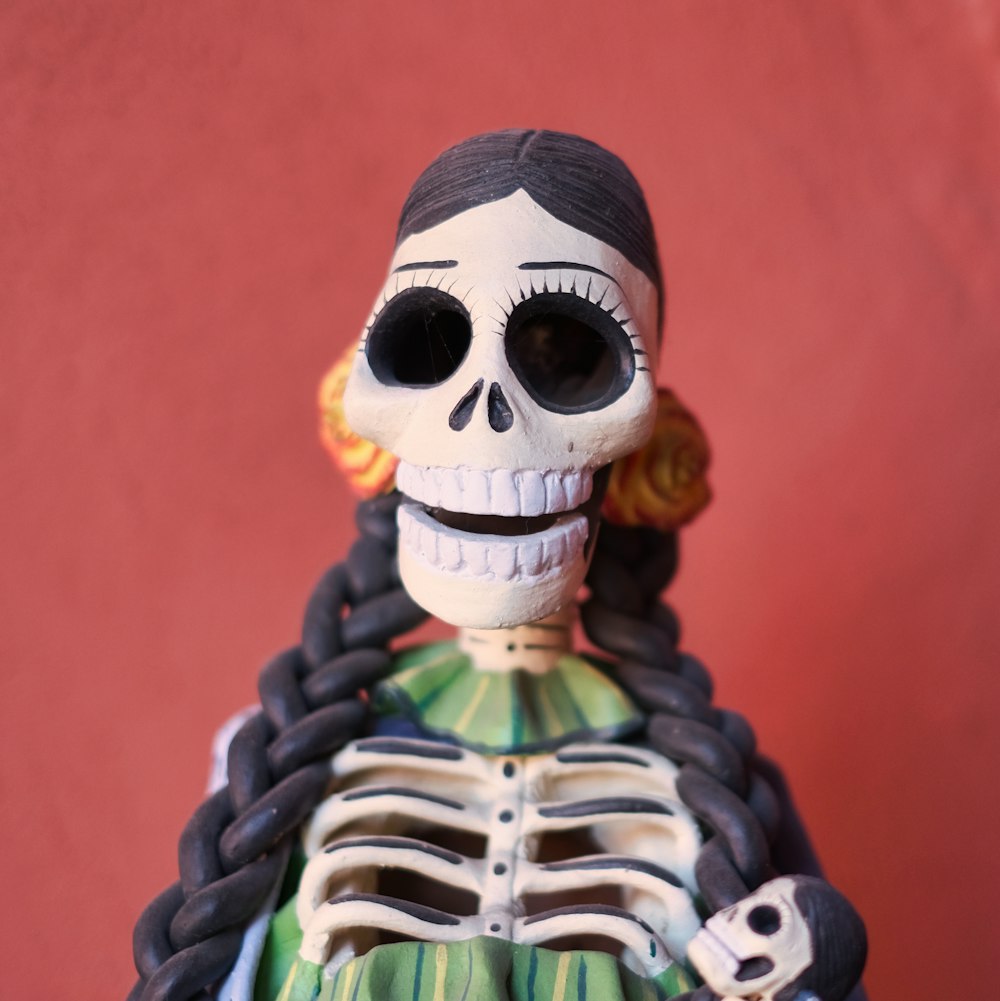 a skeleton figurine wearing a green dress