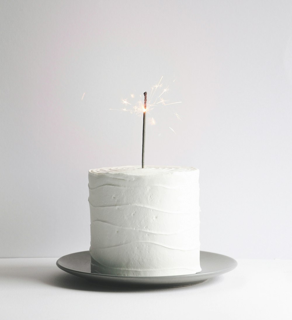 a white cake with a sparkler on top of it