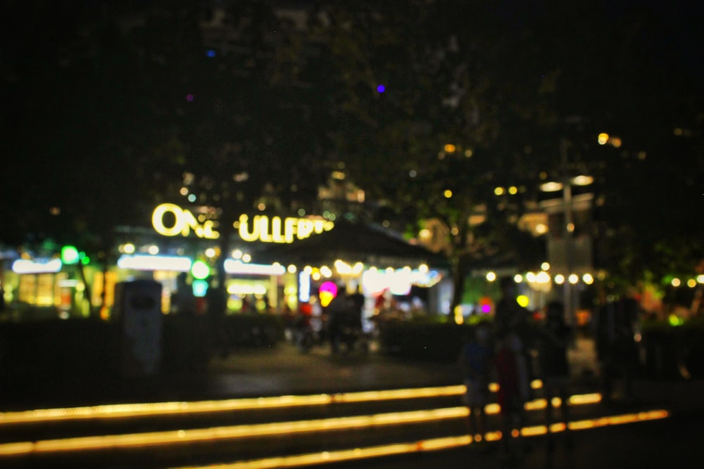 a group of people standing outside of a building at night