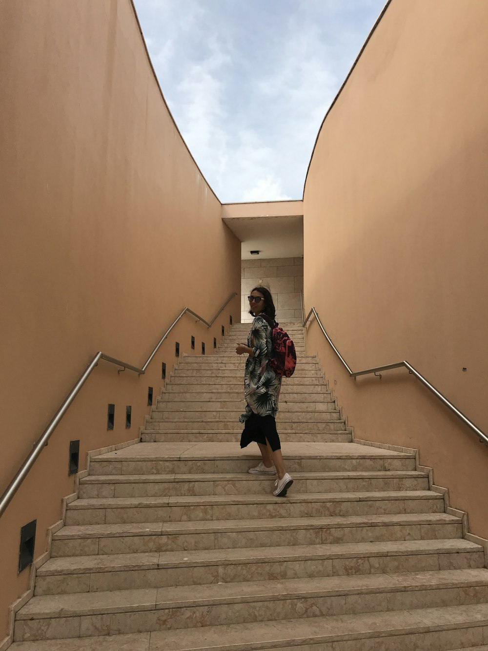 a woman walking down a flight of stairs