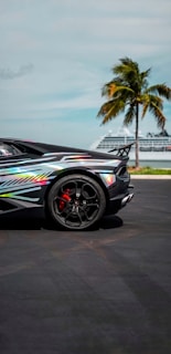 A vibrant image of a rental car parked in front of a famous Orlando attraction.