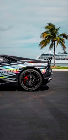 A vibrant image of a rental car parked in front of a famous Orlando attraction.