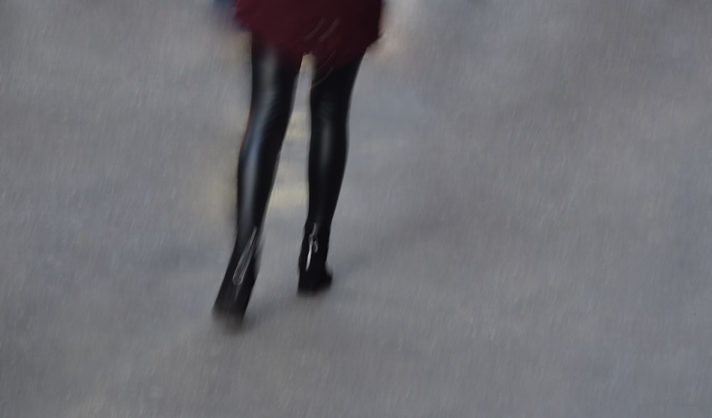 a blurry photo of a woman walking down a street