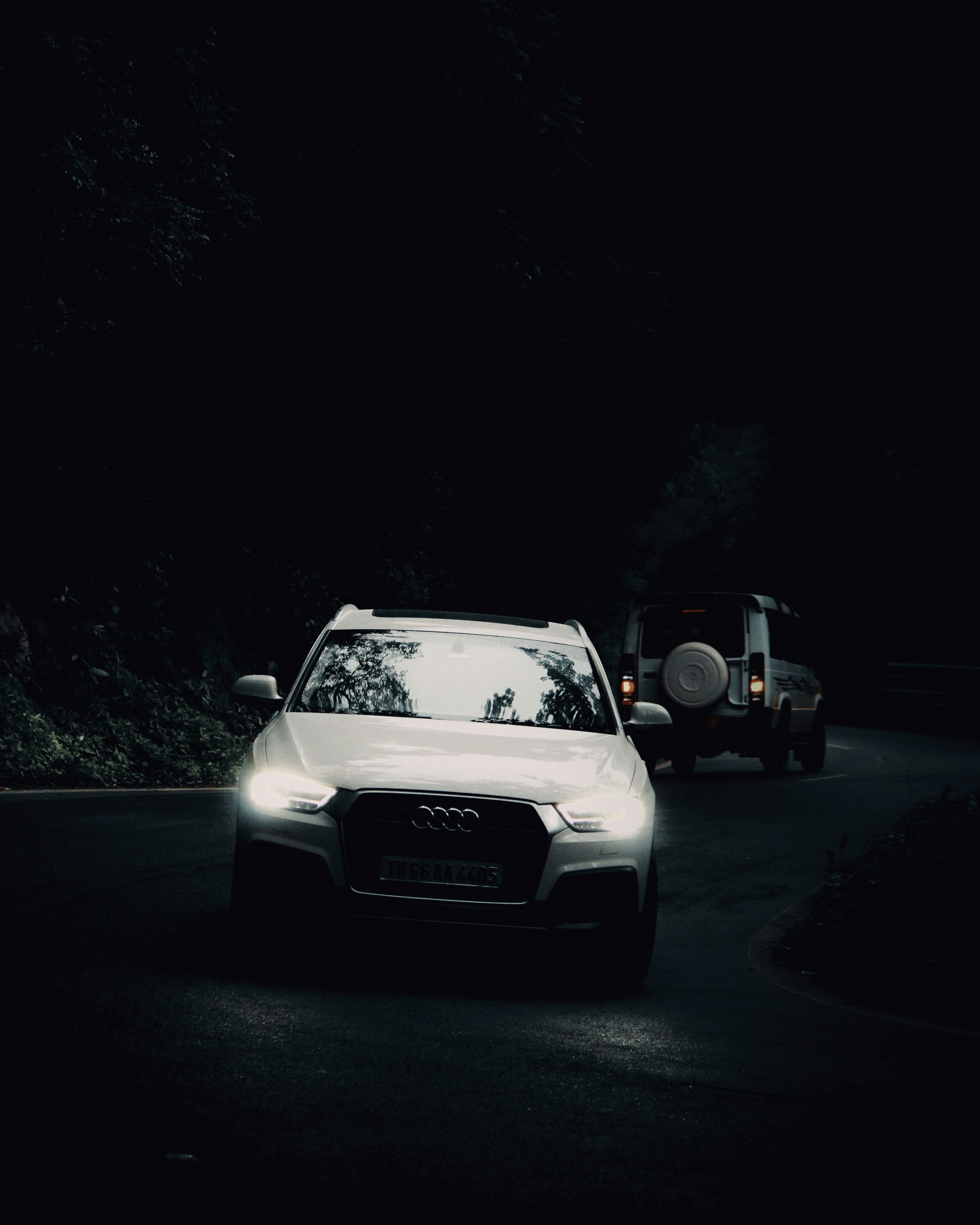 A white car driving down a street at night photo – Free India Image on ...
