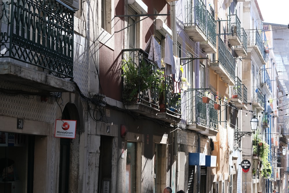 a man walking down a street next to tall buildings