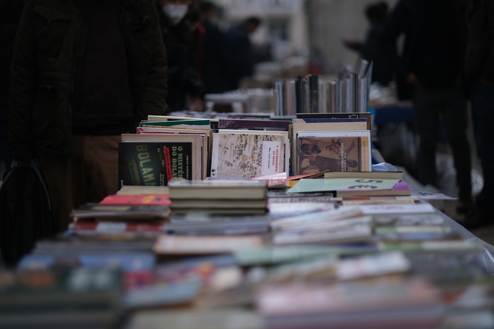 a table full of books on a city street