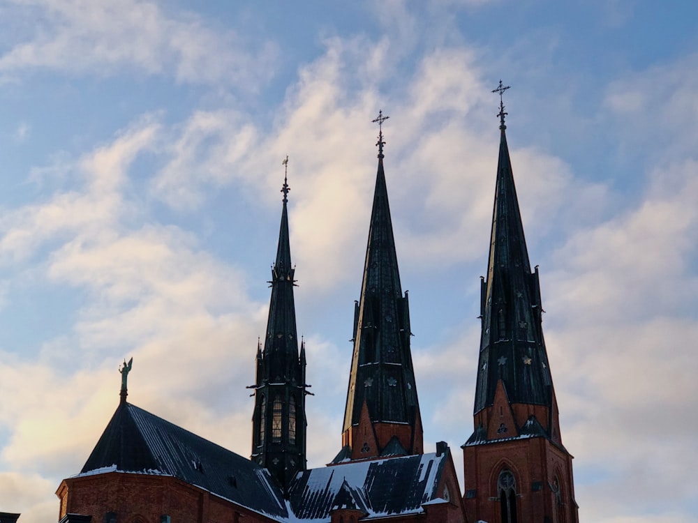 a church with three steeples and snow on the ground