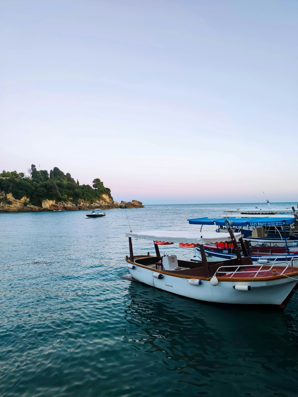 a group of boats floating on top of a body of water