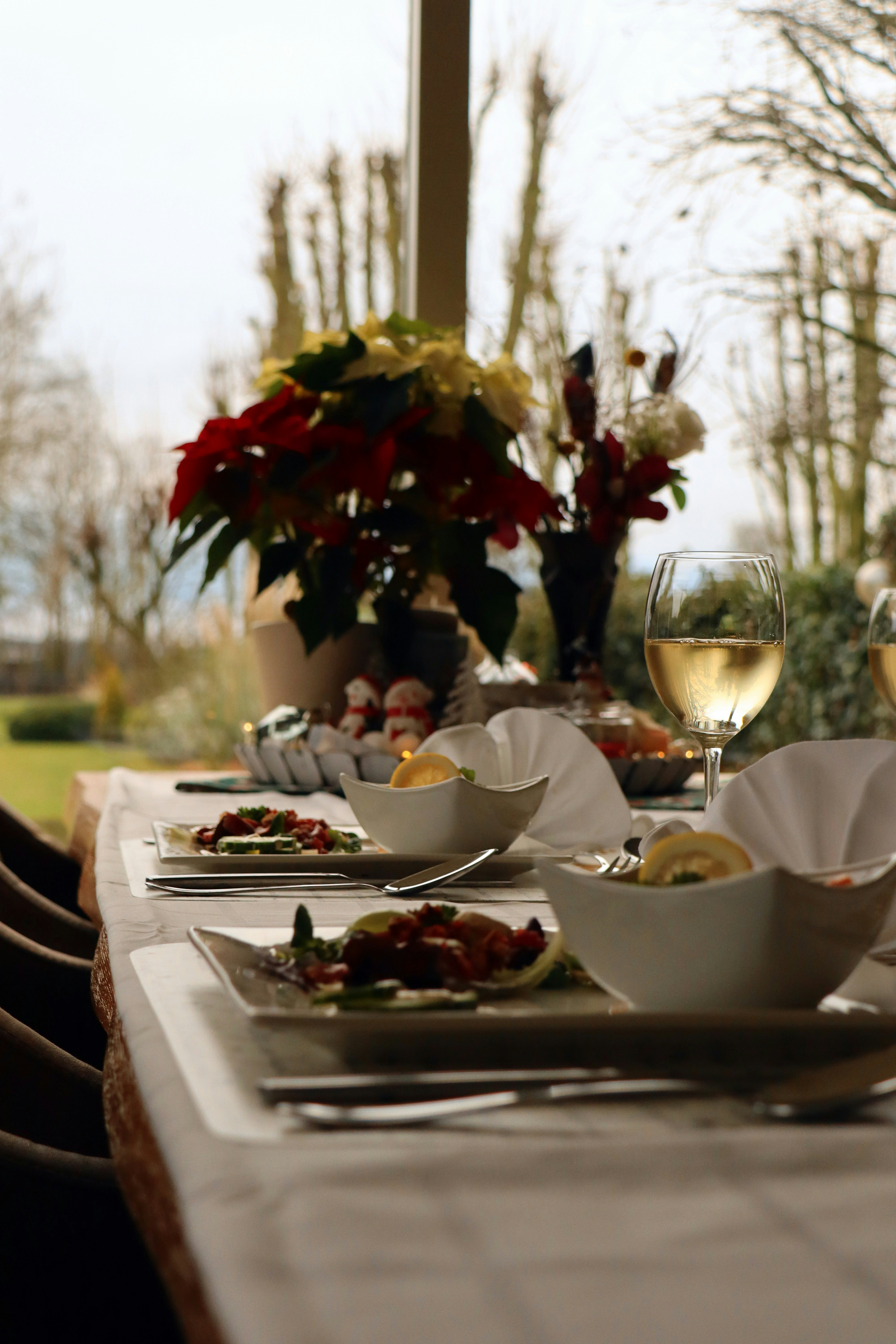 a table with plates of food and glasses of wine