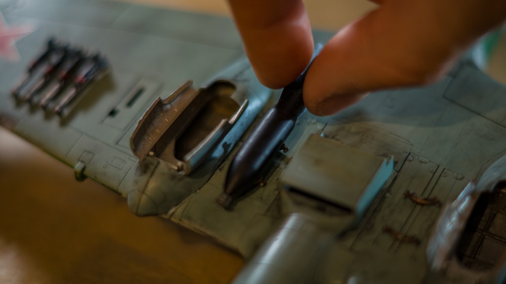 a close up of a person cutting a piece of metal