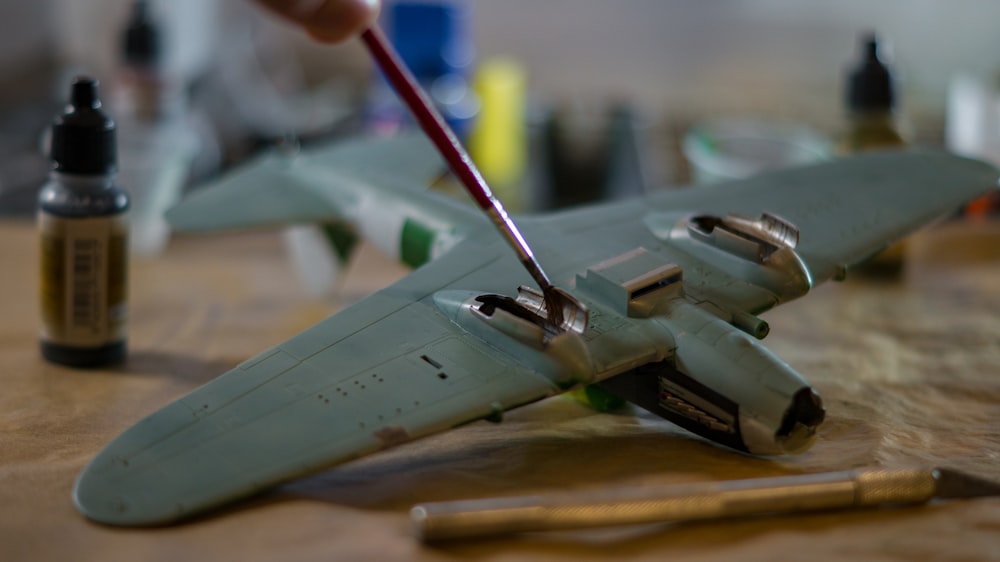 a toy model of a fighter jet being worked on