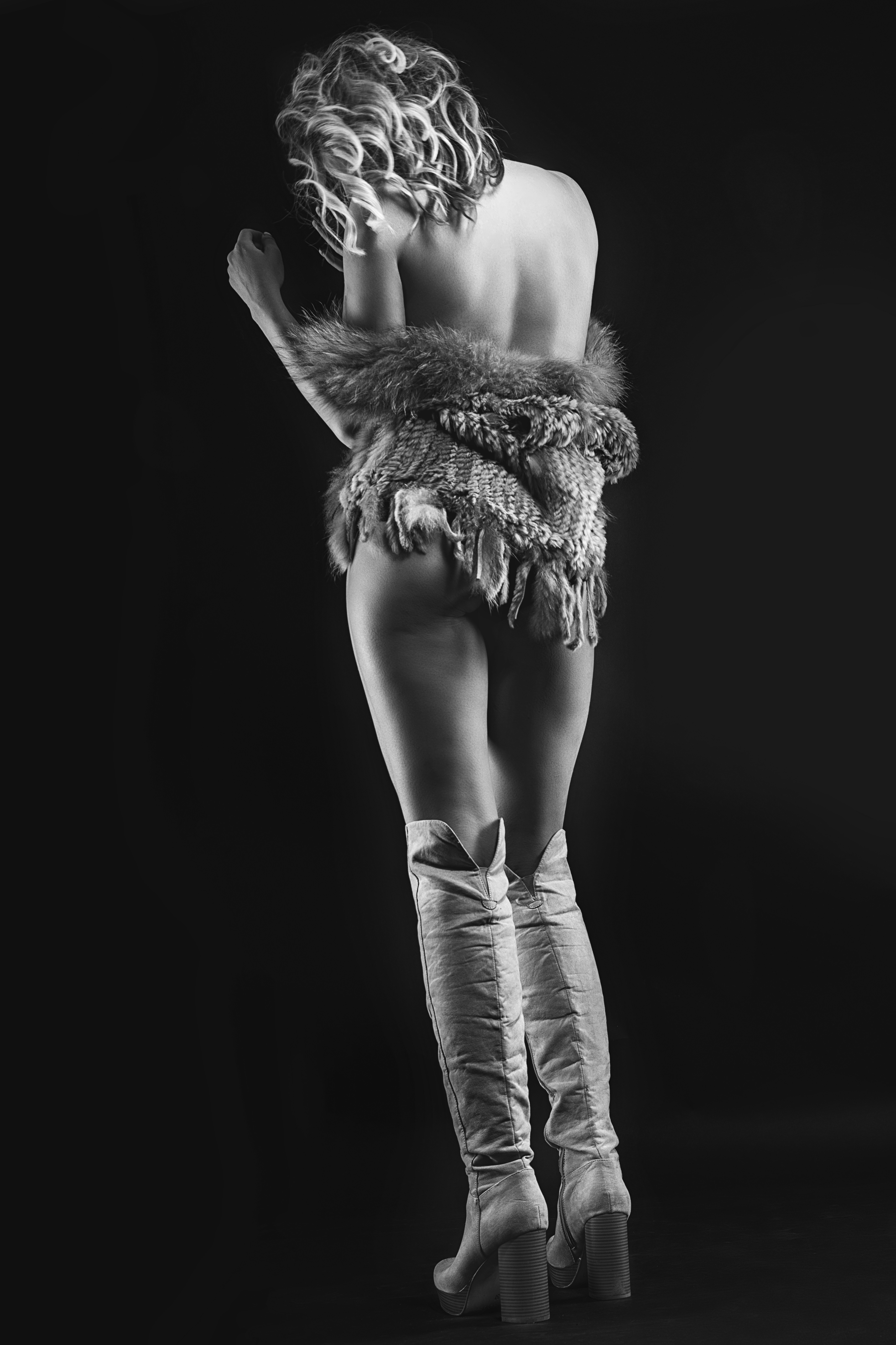 a woman wearing boots and a fur stole