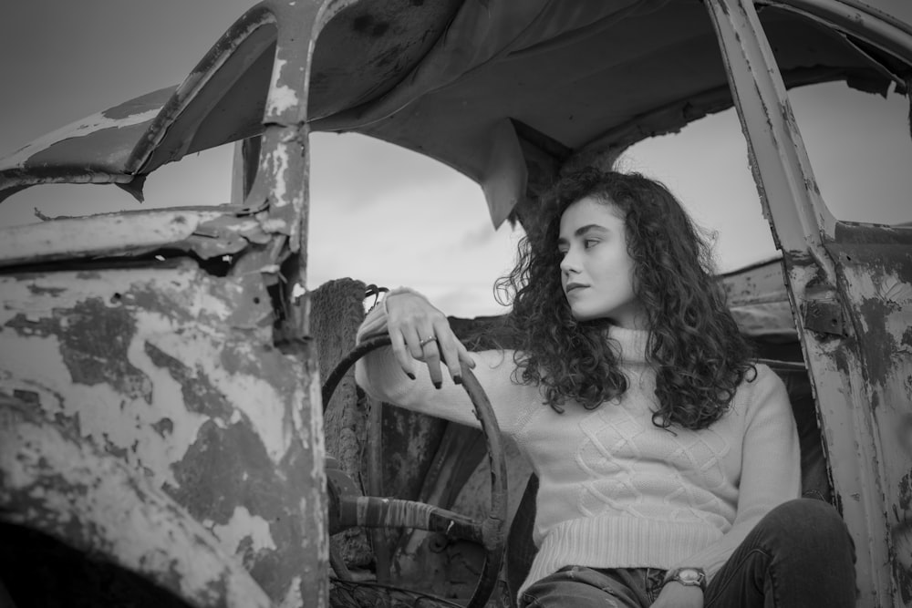 a woman sitting in the back of an old truck