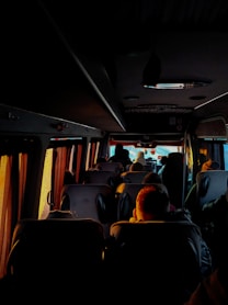 a group of people sitting on a bus at night