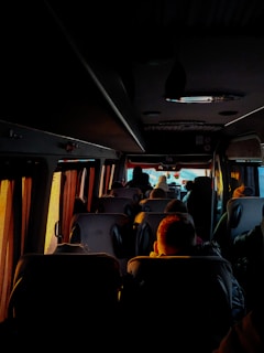 a group of people sitting on a bus at night