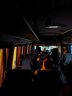 a group of people sitting on a bus at night