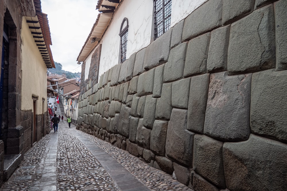 a cobblestone street lined with stone buildings