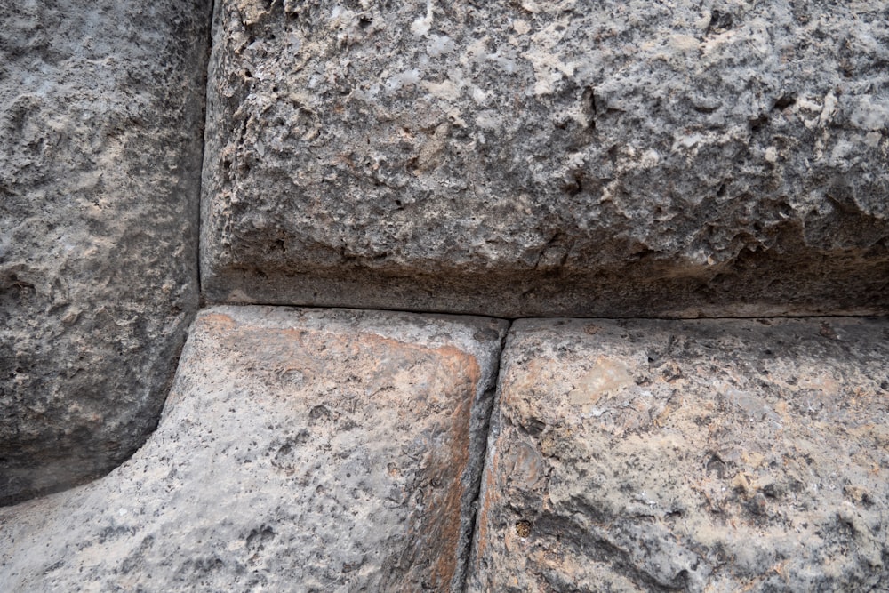 a close up of a rock wall with small cracks