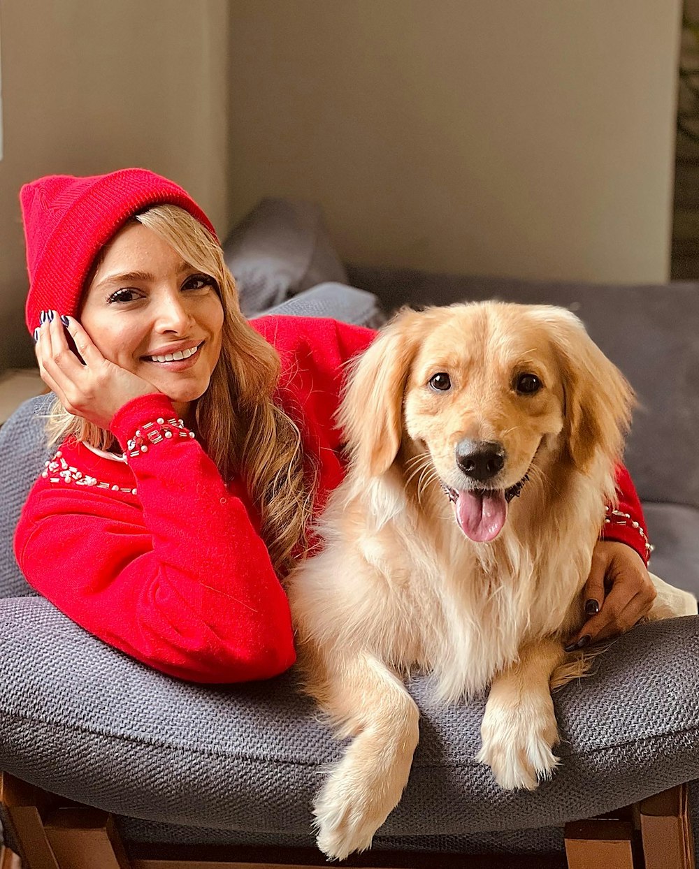 a woman sitting on a chair with a dog