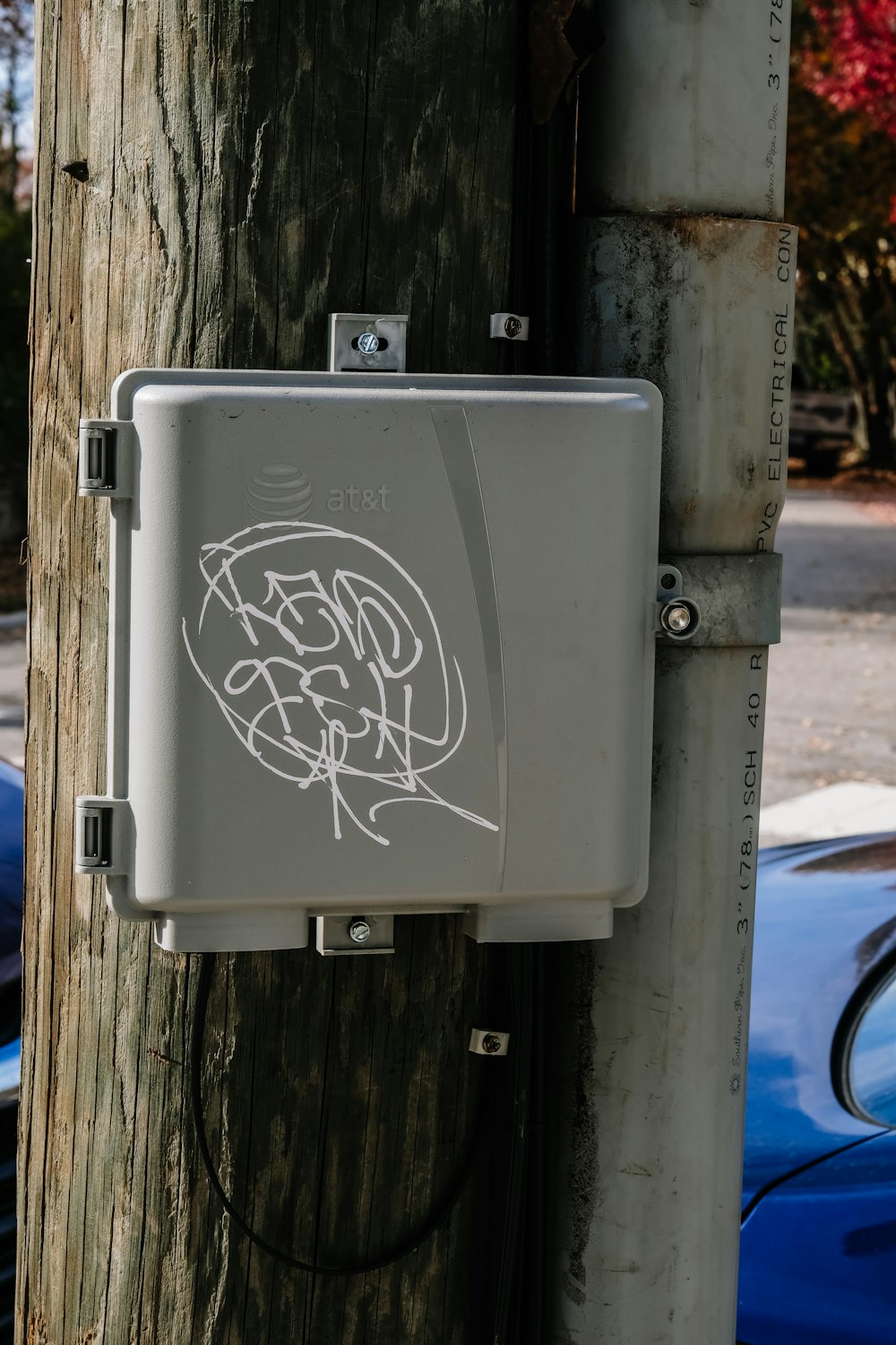 a white box attached to a wooden pole