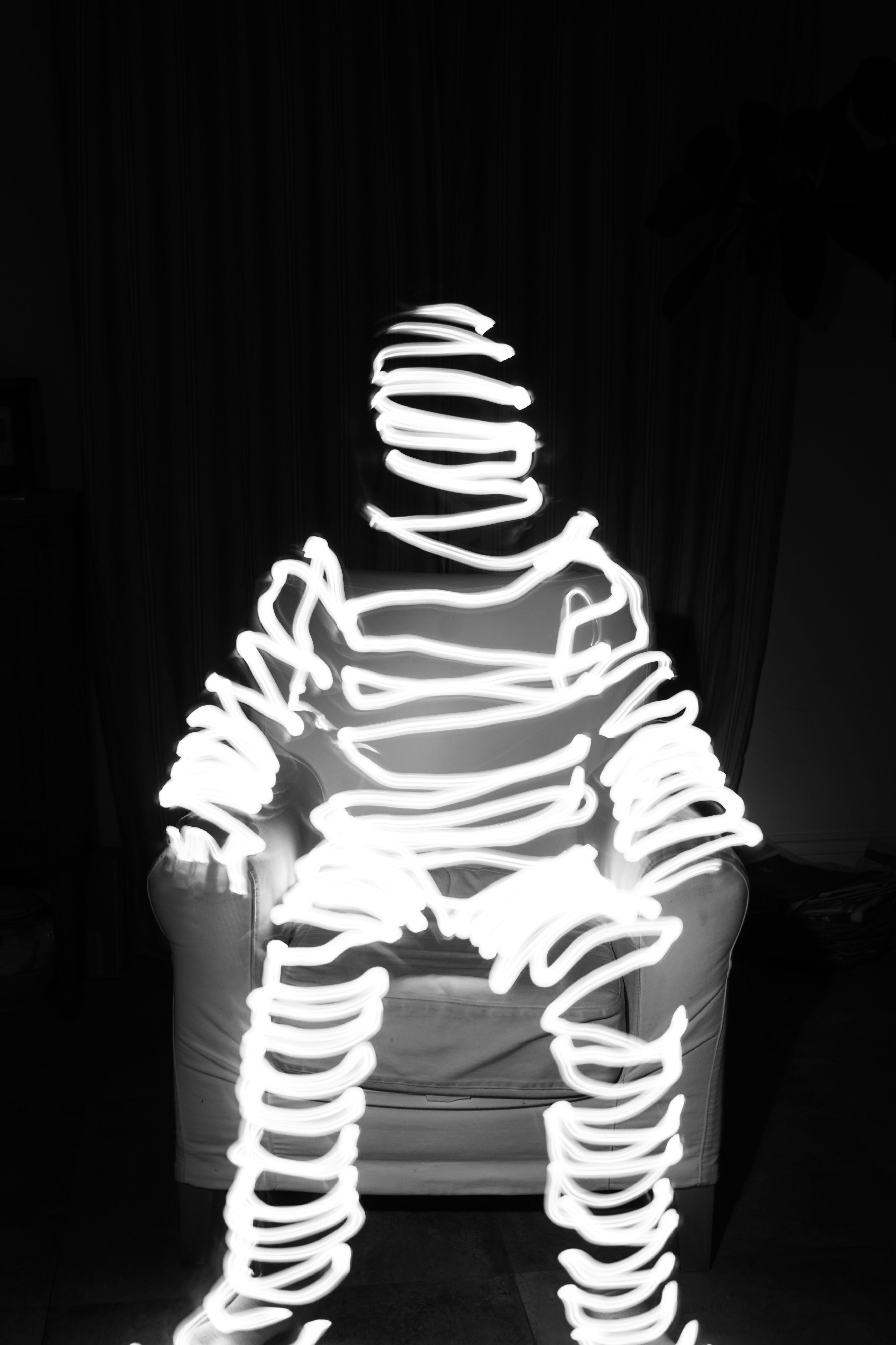 a black and white photo of a person sitting in a chair
