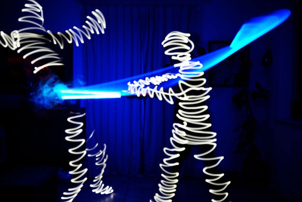 a light painting of a person holding a blue light saber