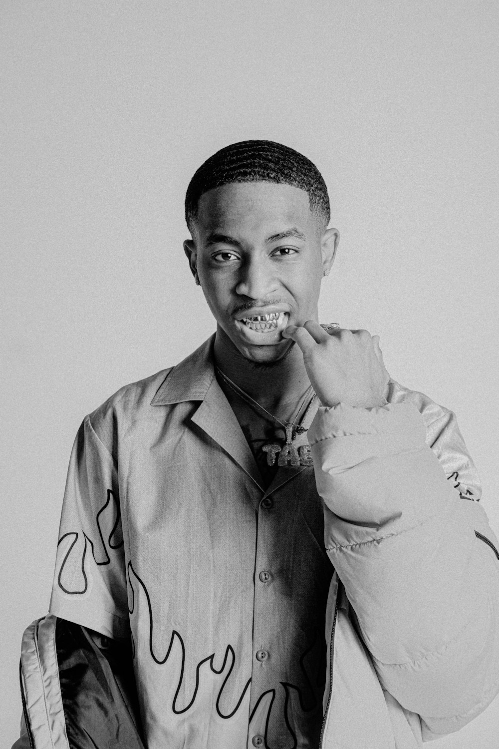 a black and white photo of a man brushing his teeth