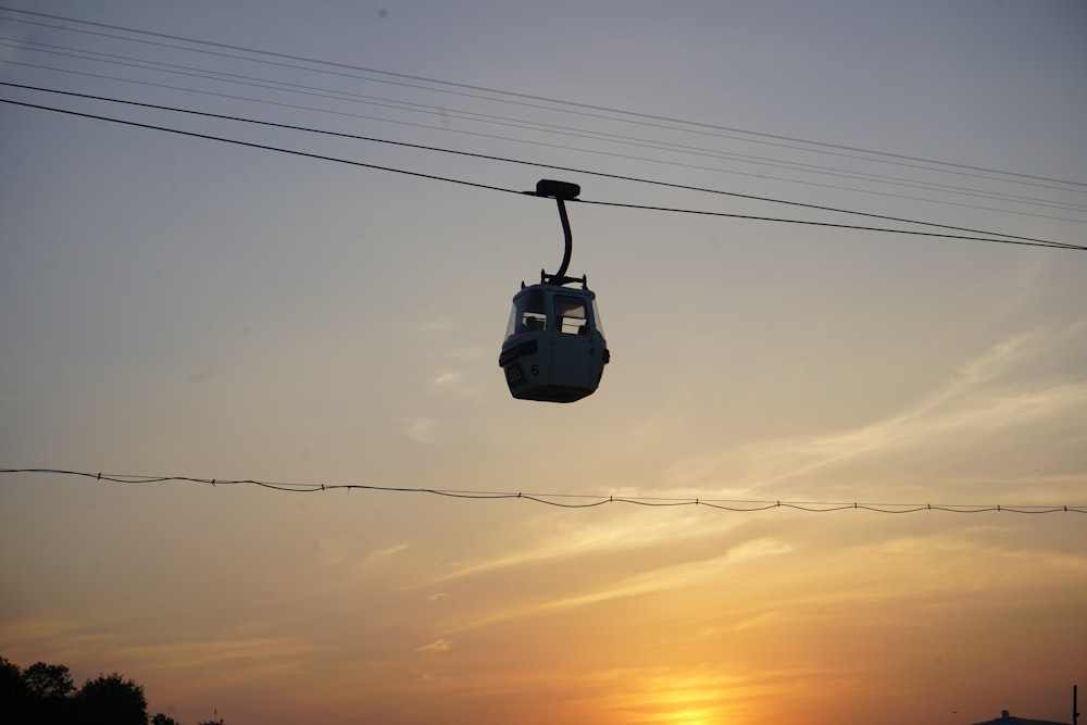 a gondola with the sun setting in the background