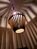 A geometric crystal lamp casting intricate shadow patterns on a cozy wall.