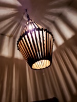 Close-up of a 3D printed geometric lamp casting intricate shadows.