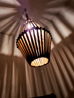 A creative 3D printed lamp with geometric patterns casting interesting shadows.