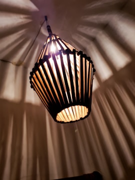 A custom-made laser-cut lamp casting warm shadows on a wall