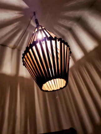A geometric crystal lamp casting intricate shadow patterns on a cozy wall.