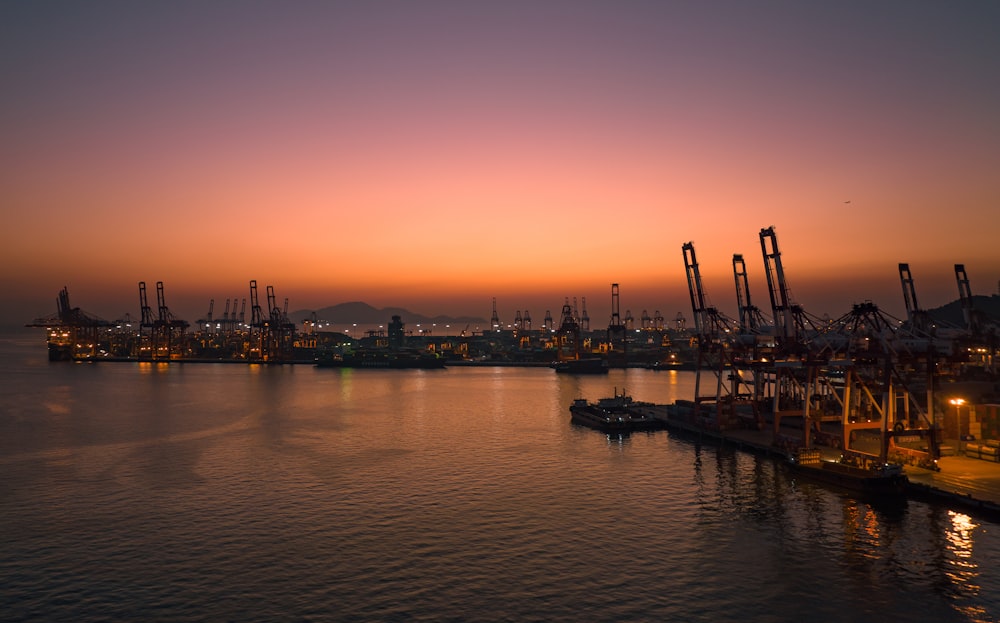 a harbor filled with lots of boats at sunset