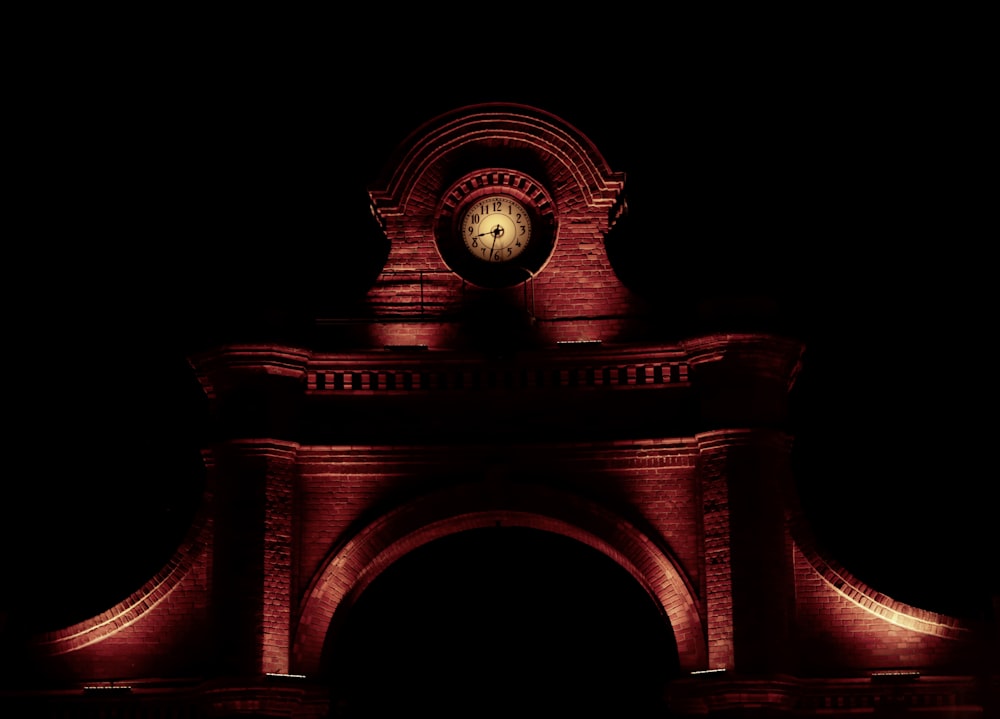 a clock is lit up in the dark