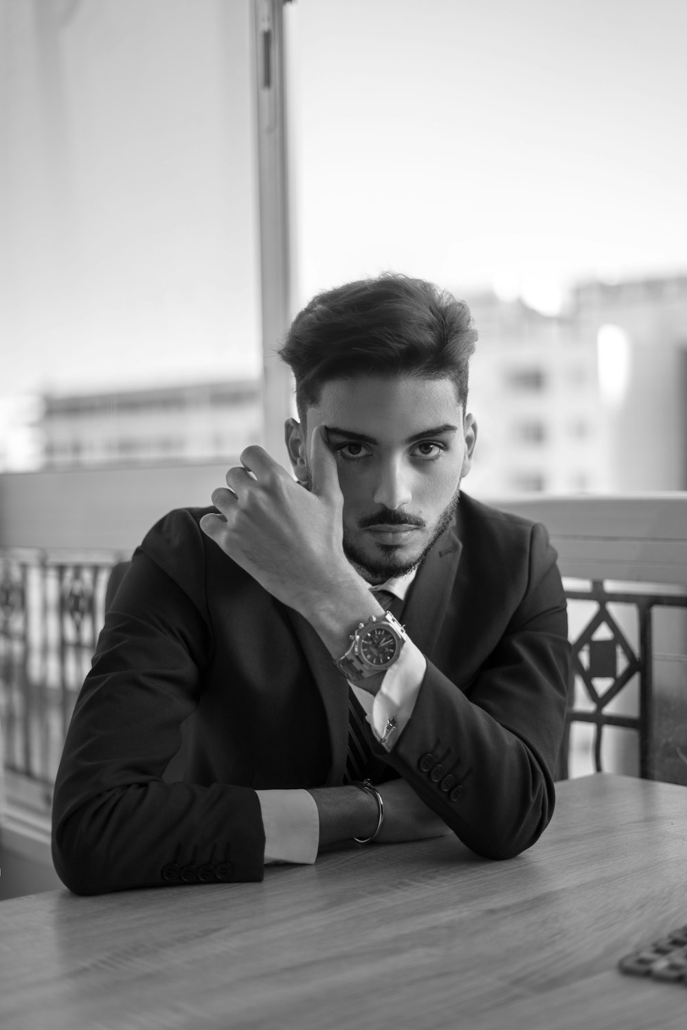 a man in a suit sitting at a table