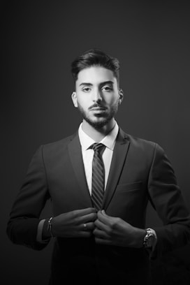 a man in a suit and tie posing for a picture
