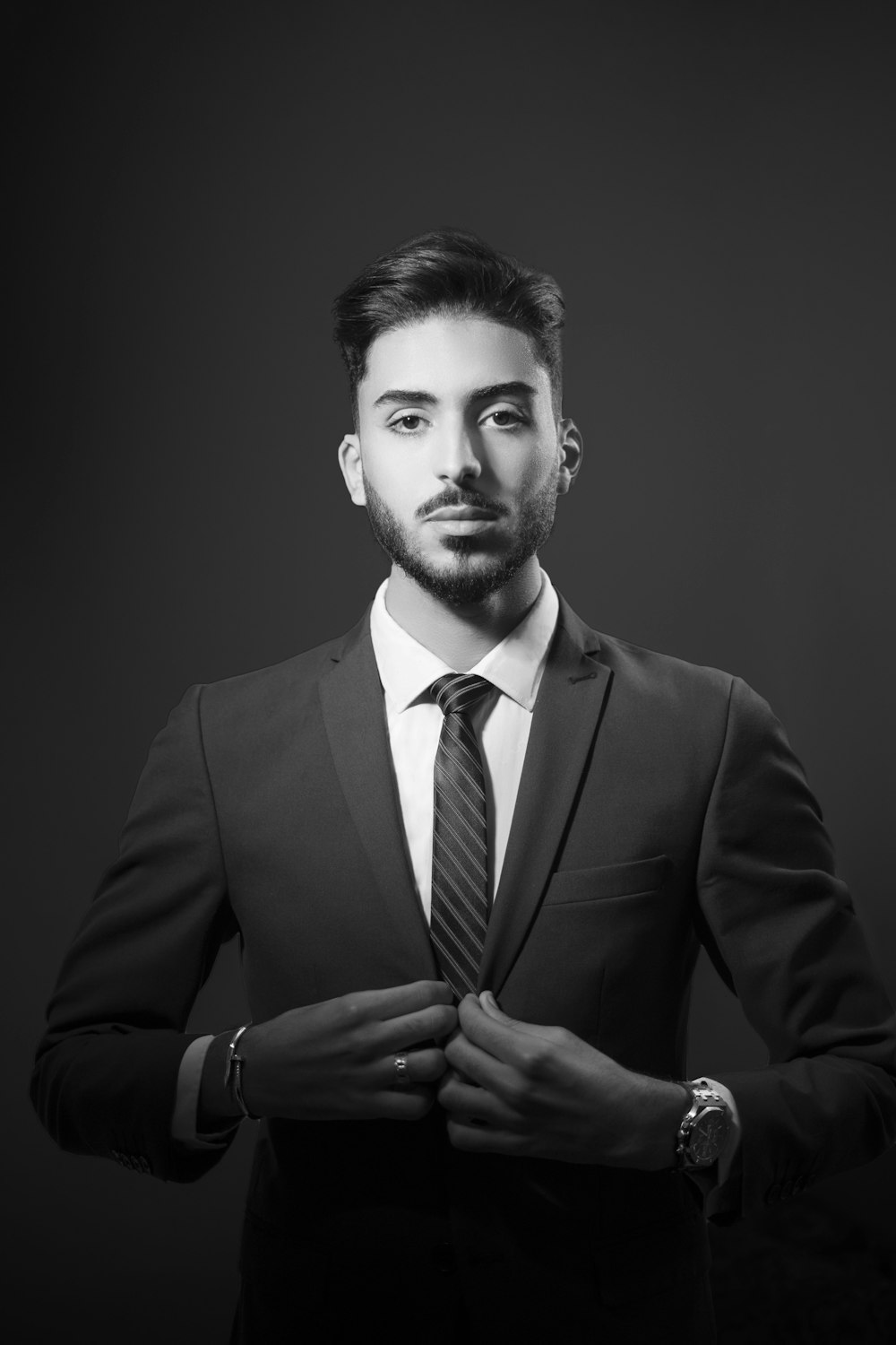 a man in a suit and tie posing for a picture