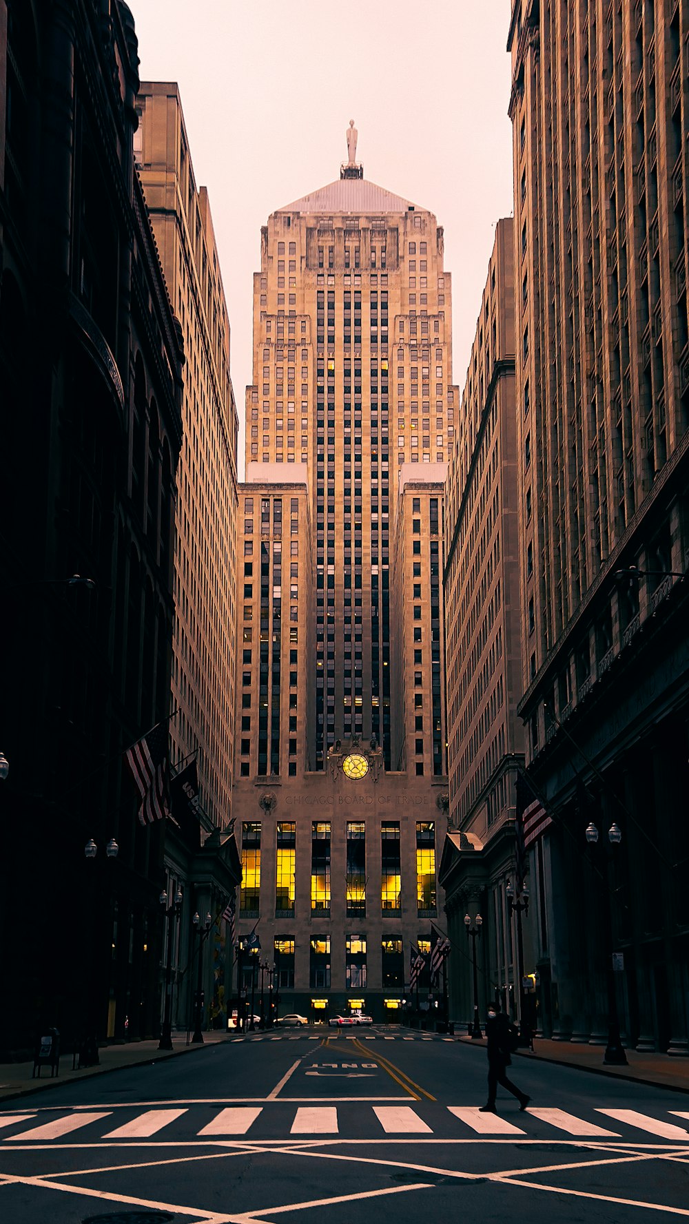 a city street with tall buildings and a crosswalk