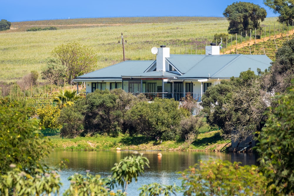 a house sitting on top of a lush green hillside