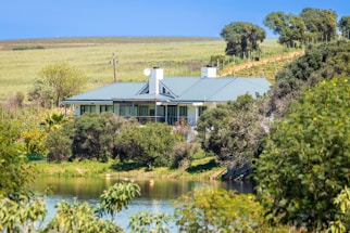 a house sitting on top of a lush green hillside