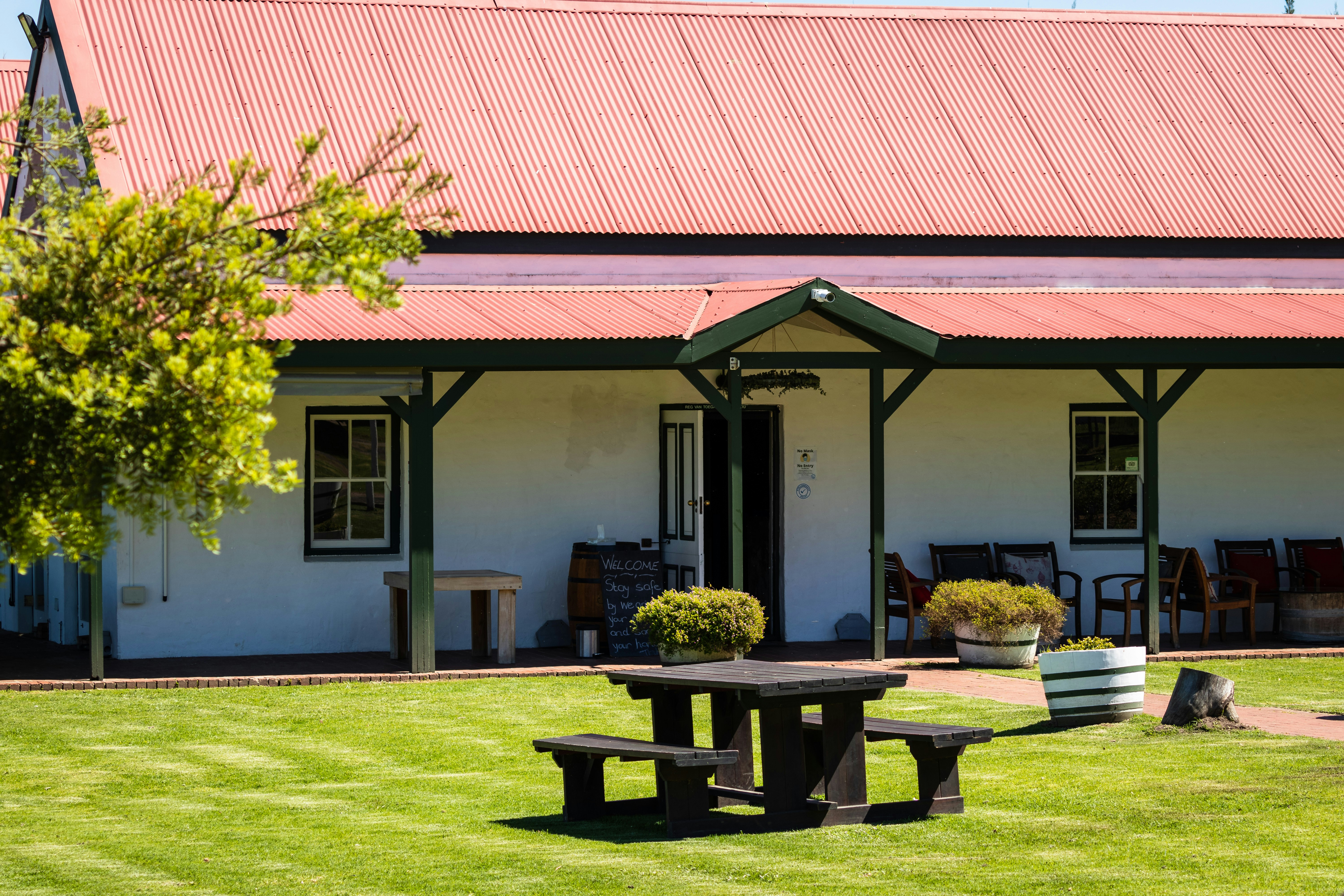 a picnic table in front of a white building