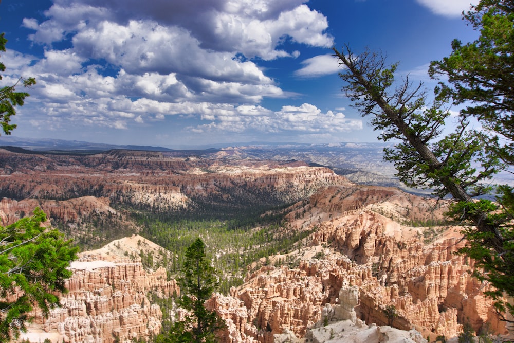 a scenic view of a valley surrounded by mountains