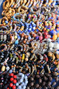 A vibrant assortment of colorful beads and gemstones arranged artfully on a velvet cloth.