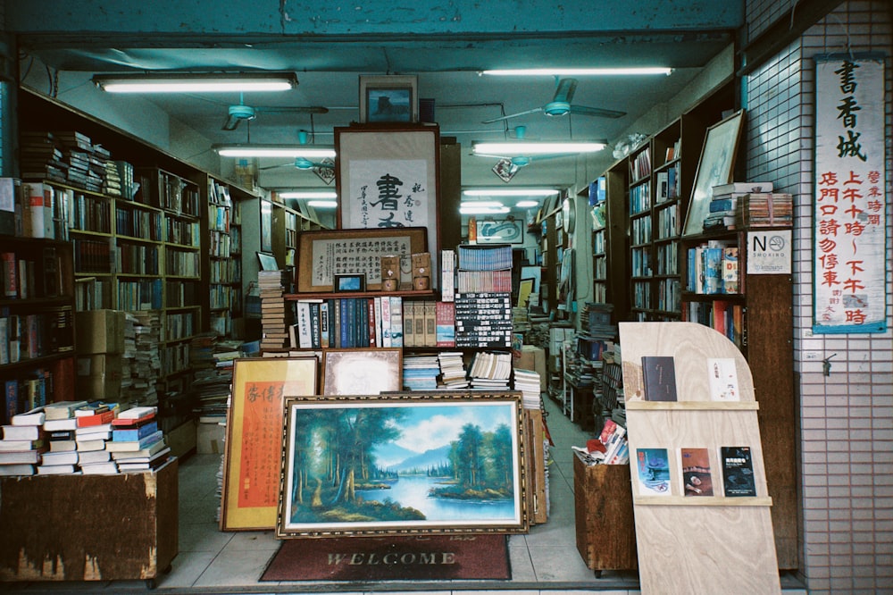 a room filled with lots of books and paintings