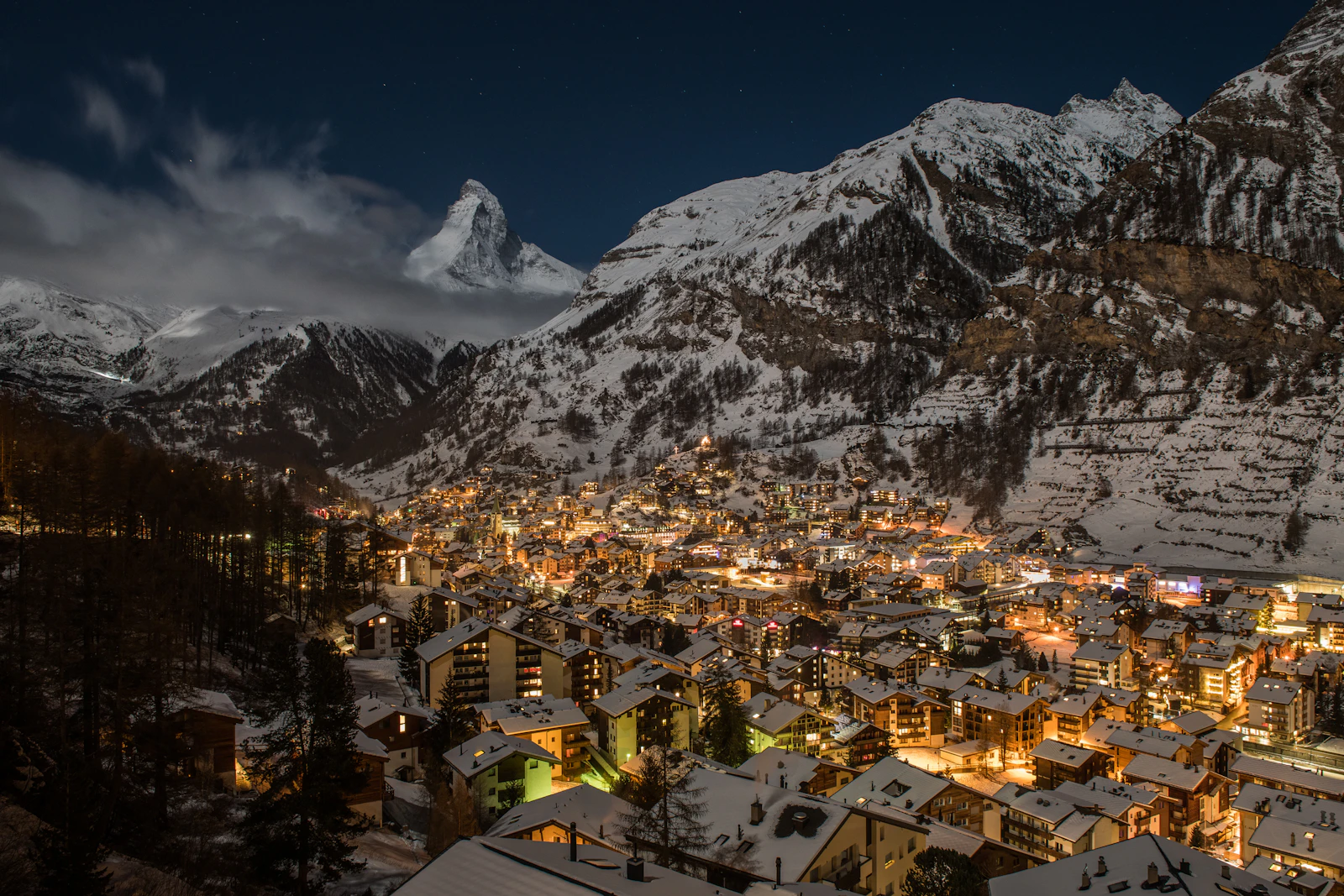 Zermatt village beneath snowy mountains in winter