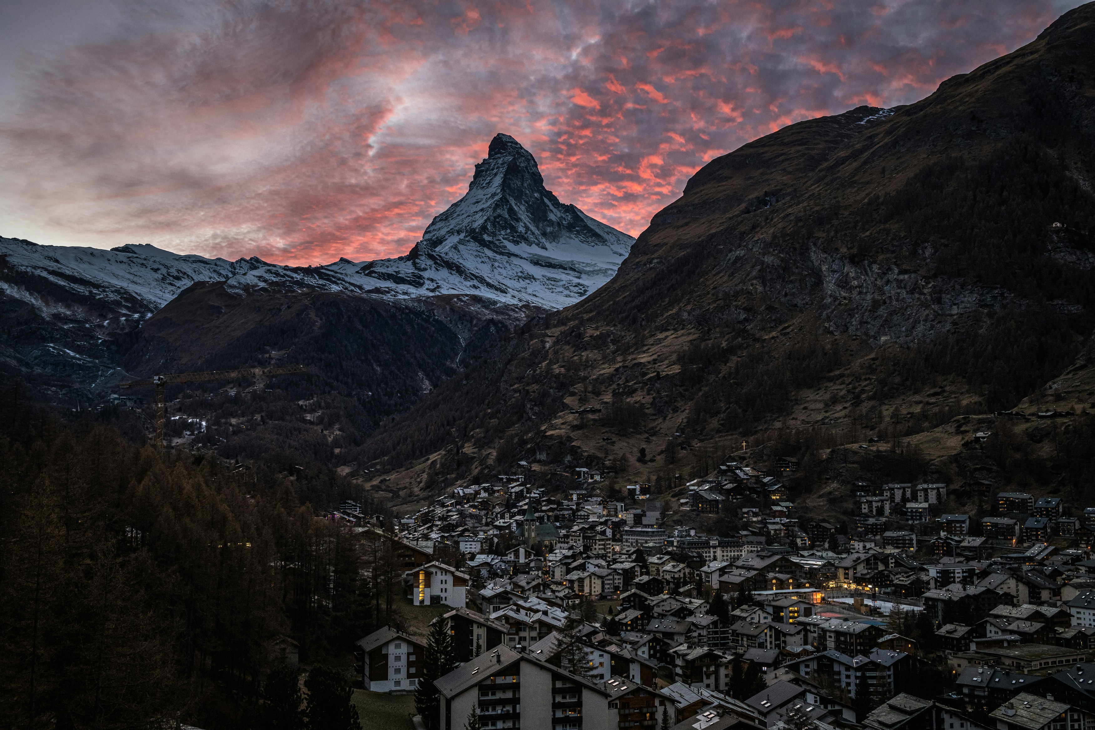 The village of Zermatt at sunset with the Matterhorn rising behind the rooftops