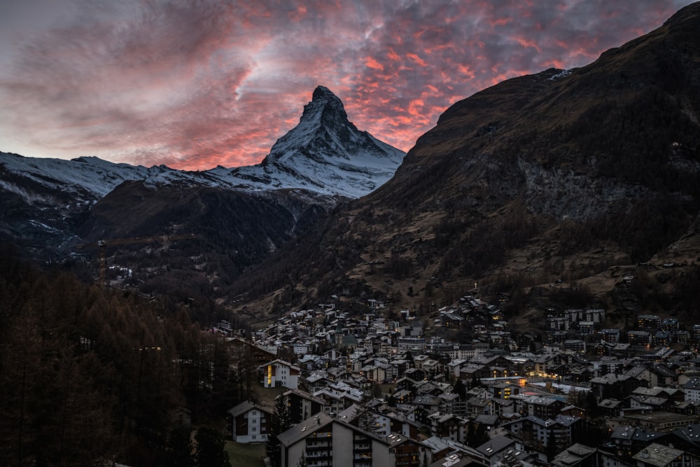 a view of a town and a mountain at sunset