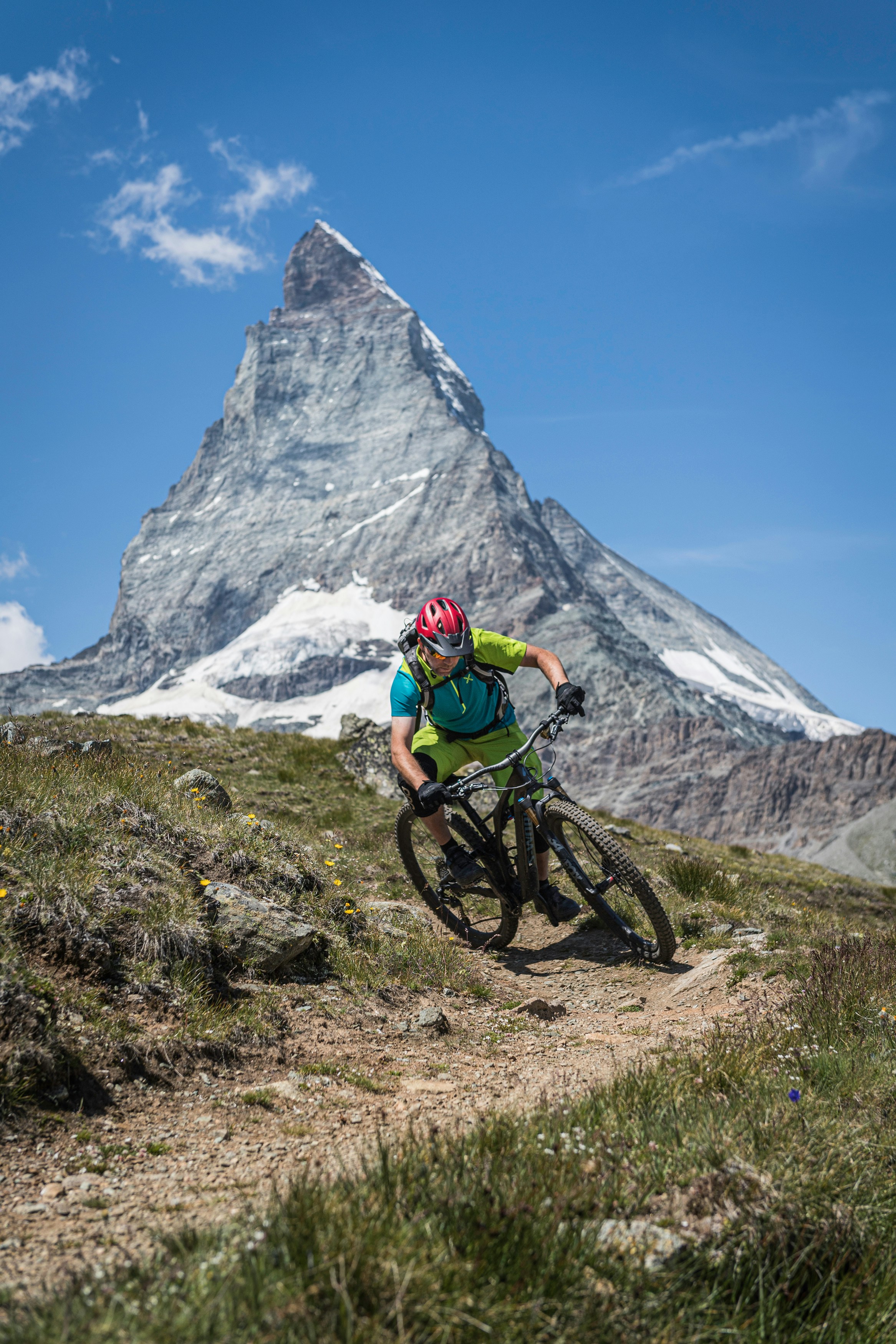 a man riding a mountain bike down a dirt trail
