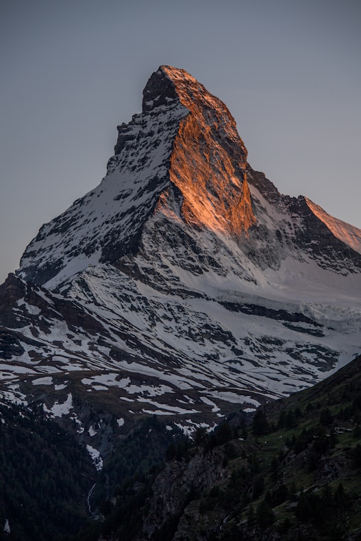 a very tall mountain with snow on it